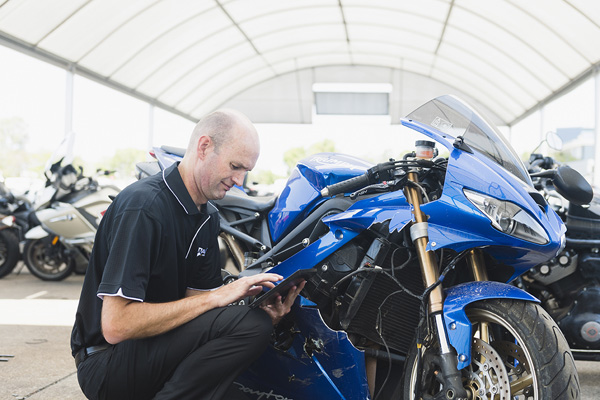 technician checking a motorbike