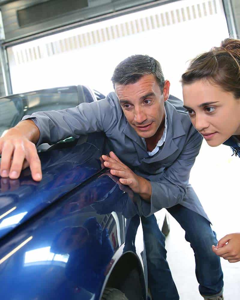 employees checking the body of a car