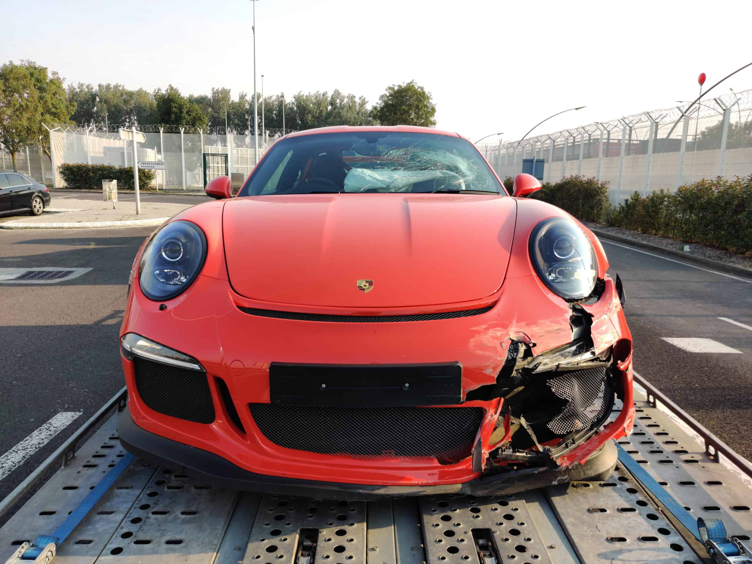 damaged red porsche