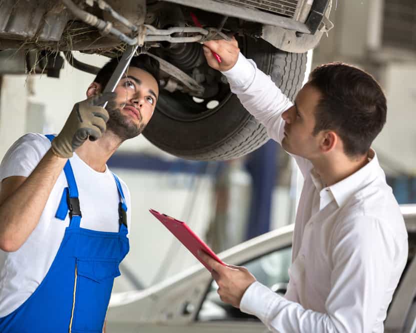 assessor and repair man examine to the car damage